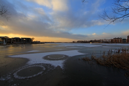 extremely gloomy weather, frozen river in a parkの写真素材