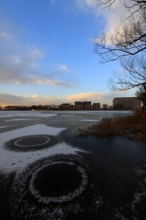 extremely gloomy weather, frozen river in a parkの写真素材