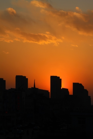 building under the setting sun in a city, chinaの写真素材
