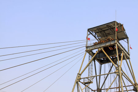 drilling derrick in a iron mine in the blue sky