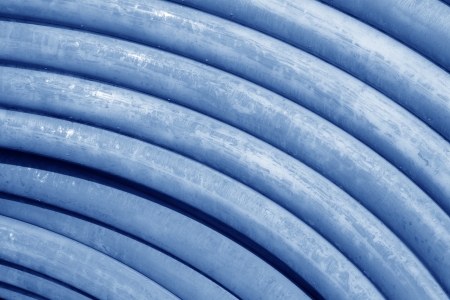 plastic pipe stacked toghter at a construction site の写真素材