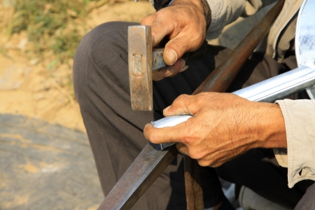 Worker metal craftsman, an artisan detail, tradition and old workの写真素材