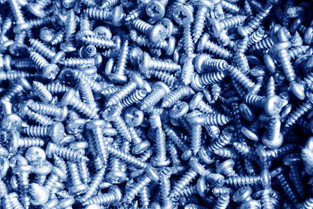 metal parts, piles and piles of screws in a marketの写真素材