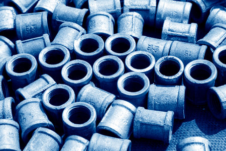 Metal plumbing pipe fittings piled up together