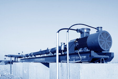 CAOFEIDIAN - DECEMBER 1: The oil industry machinery and equipment on the cement platform in the JiDong oilfield, on December 1, 2013, caofeidian, hebei province, China. のeditorial素材