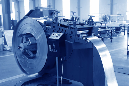 TANGSHAN - DECEMBER 22: The Strip steel processing equipment on the production line, in a solar equipment production workshop on december 22, 2013, tangshan, china.のeditorial素材