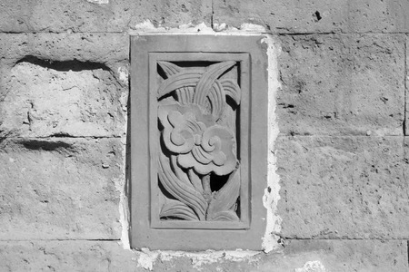 carve patterns on the gray walls, closeup of photoの写真素材