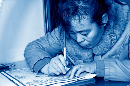 FUCHENG - DECEMBER 8: The female craftsmen used kedao production of paper cutting, on december 8,...