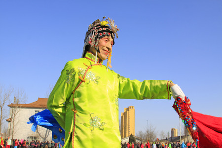 LUANNAN COUNTY - FEBRUARY 9: Old man wearing colorful clothes, performing yangko dance in the street, during the Chinese Lunar New Year, February 9, 2014, Luannan County, Hebei Province, China.
のeditorial素材