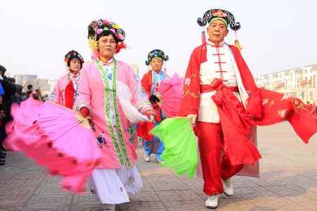 LUANNAN COUNTY - FEBRUARY 13: People wearing colorful clothes, performing yangko dance in the street, during the Chinese Lunar New Year, February 13, 2014, Luannan County, Hebei Province, China.のeditorial素材