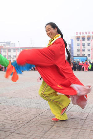 LUANNAN COUNTY - FEBRUARY 15: Performer wearing colorful clothes, performing yangko dance in the street, during the Chinese Lunar New Year, February 15, 2014, Luannan County, Hebei Province, China.のeditorial素材