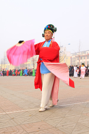 LUANNAN COUNTY - FEBRUARY 15: People wearing colorful clothes, performing yangko dance in the street, during the Chinese Lunar New Year, February 15, 2014, Luannan County, Hebei Province, China.のeditorial素材