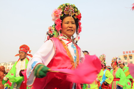 LUANNAN COUNTY - FEBRUARY 13: People wearing colorful clothes, performing yangko dance in the street, during the Chinese Lunar New Year, February 13, 2014, Luannan County, Hebei Province, China.のeditorial素材