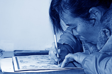 FUCHENG - DECEMBER 8: The female craftsmen used kedao production of paper cutting, on december 8, 2013, fucheng, hebei province, China. 
のeditorial素材