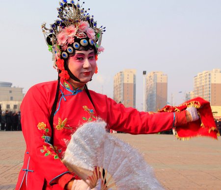 LUANNAN COUNTY - FEBRUARY 12: People wearing colorful clothes, performing yangko dance in the street, during the Chinese Lunar New Year, February 12, 2014, Luannan County, Hebei Province, China.のeditorial素材