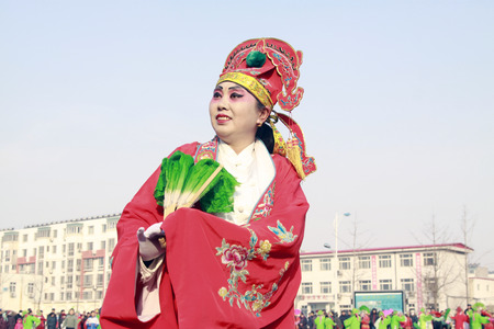 LUANNAN COUNTY - FEBRUARY 11: People wearing colorful clothes, performing yangko dance in the street, during the Chinese Lunar New Year, February 11, 2014, Luannan County, Hebei Province, China.のeditorial素材