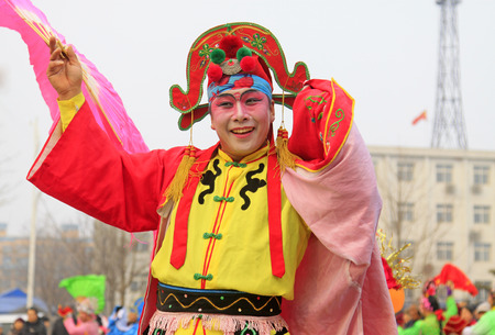 LUANNAN COUNTY - FEBRUARY 15: People wearing colorful clothes, performing yangko dance in the street, during the Chinese Lunar New Year, February 15, 2014, Luannan County, Hebei Province, China.のeditorial素材