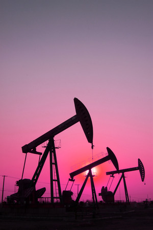 CAOFEIDIAN - DECEMBER 1: The crank balanced beam pumping unit under the curtain of night in the JiDong oilfield, on December 1, 2013, caofeidian, hebei province, China. 
のeditorial素材