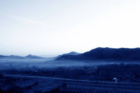 small mountain village scenery in the mist, north chinaの写真素材
