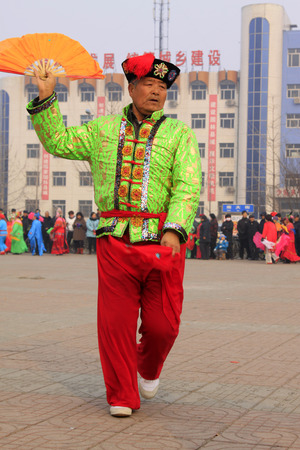 LUANNAN COUNTY - FEBRUARY 15: People wearing colorful clothes, performing yangko dance in the street, during the Chinese Lunar New Year, February 15, 2014, Luannan County, Hebei Province, China.のeditorial素材
