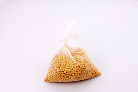 Soy beans in a transparent plastic bag, closeup of photoの写真素材