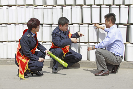 LUANNAN - MAY 4: Tax officials in ceramics factory visit, on May 4, 2014, Luannan county, hebei province, China. 
 のeditorial素材