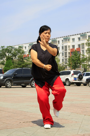 LUANNAN COUNTY - JUNE 29: lady was performing shadowboxing in the square, on june 29, 2014, LuanNan county, hebei province, China 
のeditorial素材