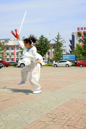LUANNAN COUNTY - JUNE 29: girl in white was performing fencing in the square, on june 29, 2014, LuanNan county, hebei province, China 
のeditorial素材
