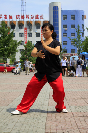 LUANNAN COUNTY - JUNE 29: lady was performing shadowboxing in the square, on june 29, 2014, LuanNan county, hebei province, China 
のeditorial素材