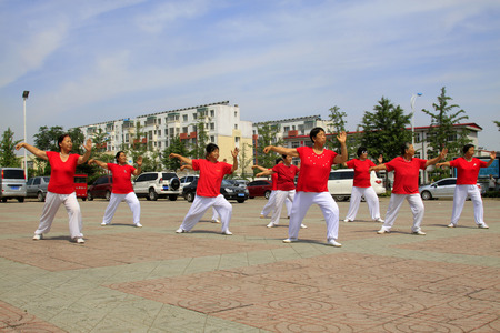 LUANNAN COUNTY - JUNE 29: A group of people were performing shadowboxing in the square, on june 29, 2014, LuanNan county, hebei province, China 
 のeditorial素材