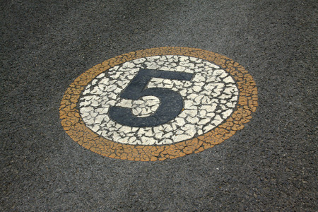 Numbers signs on the asphalt road, closeup of photoの写真素材