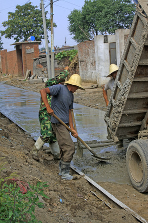 LUANNAN COUNTY - AUGUST 15: villagers concreting roads in the countryside, on august 15, 2014, Luannan County, Hebei Province, China 
のeditorial素材