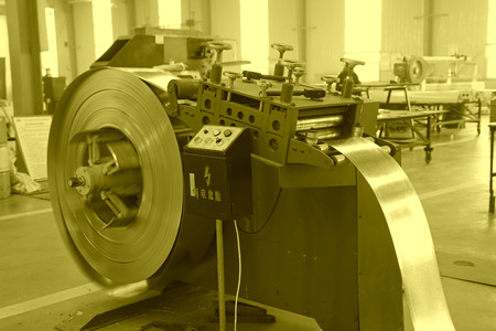 TANGSHAN - DECEMBER 22: The Strip steel processing equipment on the production line, in a solar equipment production workshop on december 22, 2013, tangshan, china.のeditorial素材