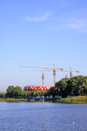 LUANNAN COUNTY - SEPTEMBER 3: red buildings and tower crane at a construction site, on september 3, 2014, Luannan County, Hebei Province, Chinaのeditorial素材