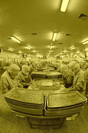 Workers in a meat processing production line, in a food processing enterprise, on December 20, 2013, tangshan city, hebei province, China.のeditorial素材
