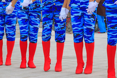 blue camouflage trousers and red boots, closeup photo