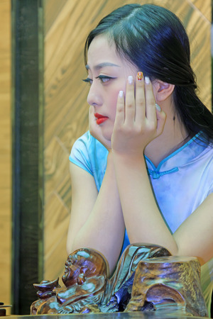 TANGSHAN CITY - SEPTEMBER 13: Female fashion models in a shop, On September 13, 2014, Tangshan City, Hebei Province, Chinaのeditorial素材