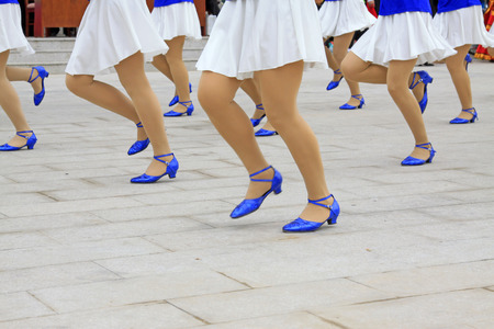 White dress and blue shoes, closeup of photoの写真素材
