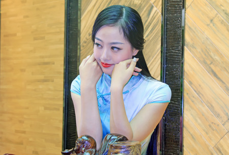 TANGSHAN CITY - SEPTEMBER 13: Female fashion models in a shop, On September 13, 2014, Tangshan City, Hebei Province, Chinaのeditorial素材