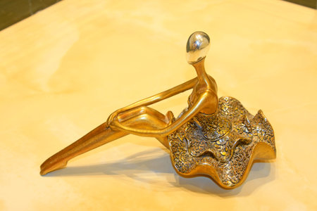 golden lady sitting position sculpture, closeup of photoのeditorial素材