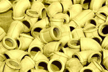 Metal plumbing pipe fittings piled up together