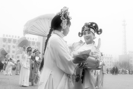 LUANNAN COUNTY - FEBRUARY 15: Performer wearing colorful clothes, performing yangko dance in the street, during the Chinese Lunar New Year, February 15, 2014, Luannan County, Hebei Province, China.のeditorial素材