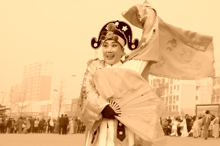 LUANNAN COUNTY - FEBRUARY 15: Performer wearing colorful clothes, performing yangko dance in the street, during the Chinese Lunar New Year, February 15, 2014, Luannan County, Hebei Province, China.のeditorial素材