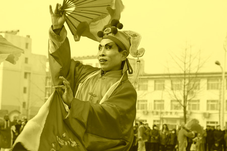 LUANNAN COUNTY - FEBRUARY 15: People wearing colorful clothes, performing yangko dance in the street, during the Chinese Lunar New Year, February 15, 2014, Luannan County, Hebei Province, China.のeditorial素材