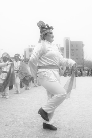 LUANNAN COUNTY - FEBRUARY 8: People wearing colorful clothes, performing yangko dance in the street, during the Chinese Lunar New Year, February 8, 2014, Luannan County, Hebei Province, China.のeditorial素材