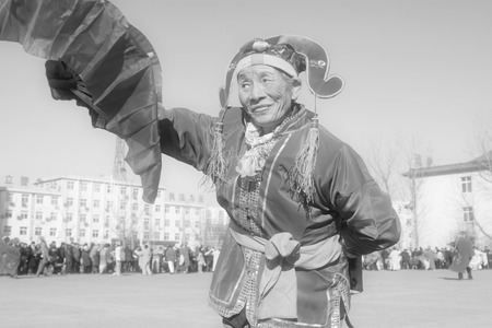LUANNAN COUNTY - FEBRUARY 9: People wearing colorful clothes, performing yangko dance in the street, during the Chinese Lunar New Year, February 9, 2014, Luannan County, Hebei Province, China.のeditorial素材