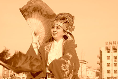 LUANNAN COUNTY - FEBRUARY 11: People wearing colorful clothes, performing yangko dance in the street, during the Chinese Lunar New Year, February 11, 2014, Luannan County, Hebei Province, China.のeditorial素材