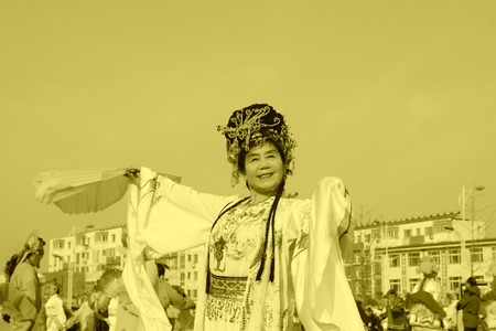 LUANNAN COUNTY - FEBRUARY 11: People wearing colorful clothes, performing yangko dance in the street, during the Chinese Lunar New Year, February 11, 2014, Luannan County, Hebei Province, China.のeditorial素材