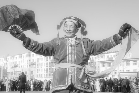 LUANNAN COUNTY - FEBRUARY 10:  Old woman wearing colorful clothes, performing yangko dance in the street, during the Chinese Lunar New Year, February 10, 2014, Luannan County, Hebei Province, China.のeditorial素材