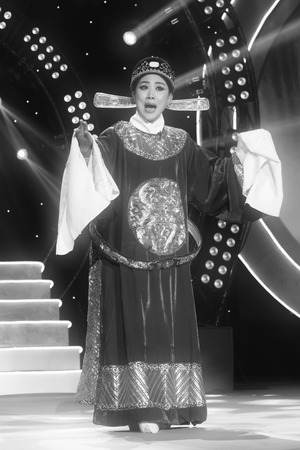 LUANNAN COUNTY - JANUARY 6: The actor wearing a sun hat performing PingJu on the stage, in the ChengZhaoCai grand theater, January 6, 2014,luannan county, hebei province, china.のeditorial素材